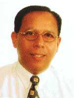 3rd Principal of BBSS. Middle-aged Malay man with glasses, wearing a white shirt and patterned tie, smiling slightly.